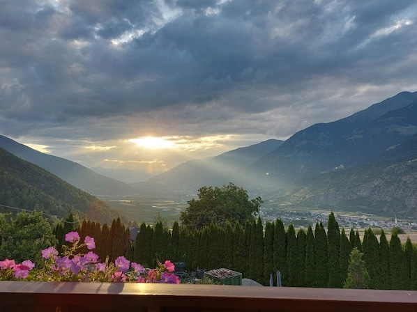 A mountainous landscape with a valley and a town below.