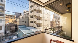 A modern building with a glass facade and a balcony with a wooden railing. - Asakusa Temple 4min Skytree 10min Japanese Cozy House  (Tokyo)