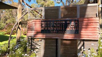 A rustic wooden structure with a sign that reads 'BULLSHIT BAR EST 1922'.