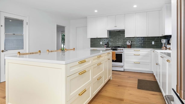 A modern kitchen with white cabinetry, a central island, and a built-in oven. - 2 Bedroom Aptos Home With Ocean View! (Aptos)