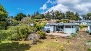 A residential area with houses, a garden, and a clear sky. - 2 Bedroom Aptos Home With Ocean View! (Aptos)