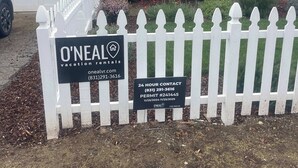 A gated property with a sign for O'Neal Vacation Rentals, including a 24-hour contact number and permit details. - 2 Bedroom Aptos Home With Ocean View! (Aptos)