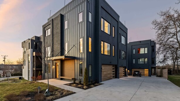 A modern two-story house with a garage, large windows, and a well-maintained lawn. - Nashville house near Geodis Park with hot tub, game room, sleeps 12 (Nashville)