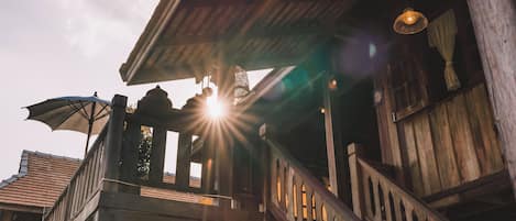 A wooden building with a balcony and a staircase.