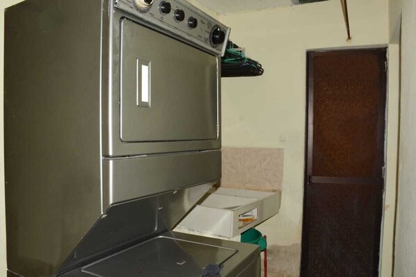 A compact kitchen with a built-in oven and a microwave.