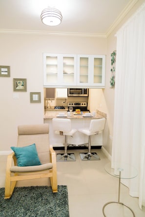 Superior Studio, Garden View | Living area | Flat-screen TV