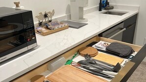 Eine Küche mit Mikrowelle, Kaffeemaschine und Spüle.
