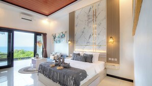 A modern bedroom with a large bed, a view of the outdoors, and a marble wall. - Reynten Hill  (Penida Island)