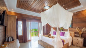 A spacious bedroom with a wooden ceiling, a large bed with a canopy, and a view of the outdoors. - Reynten Hill  (Penida Island)