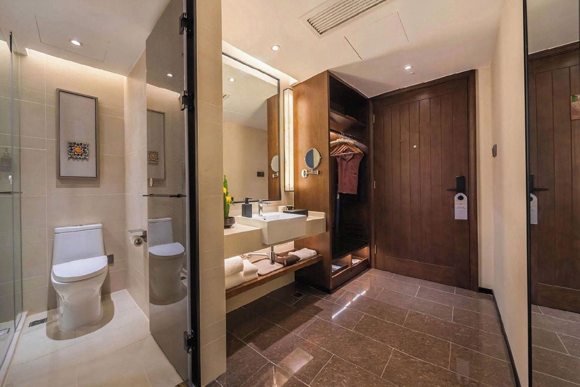 A modern bathroom with a toilet, sink, and shower area.
