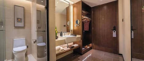 A modern bathroom with a toilet, sink, and shower area.