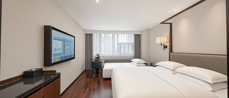A hotel room with a bed, bedside table, TV, and a window with curtains.