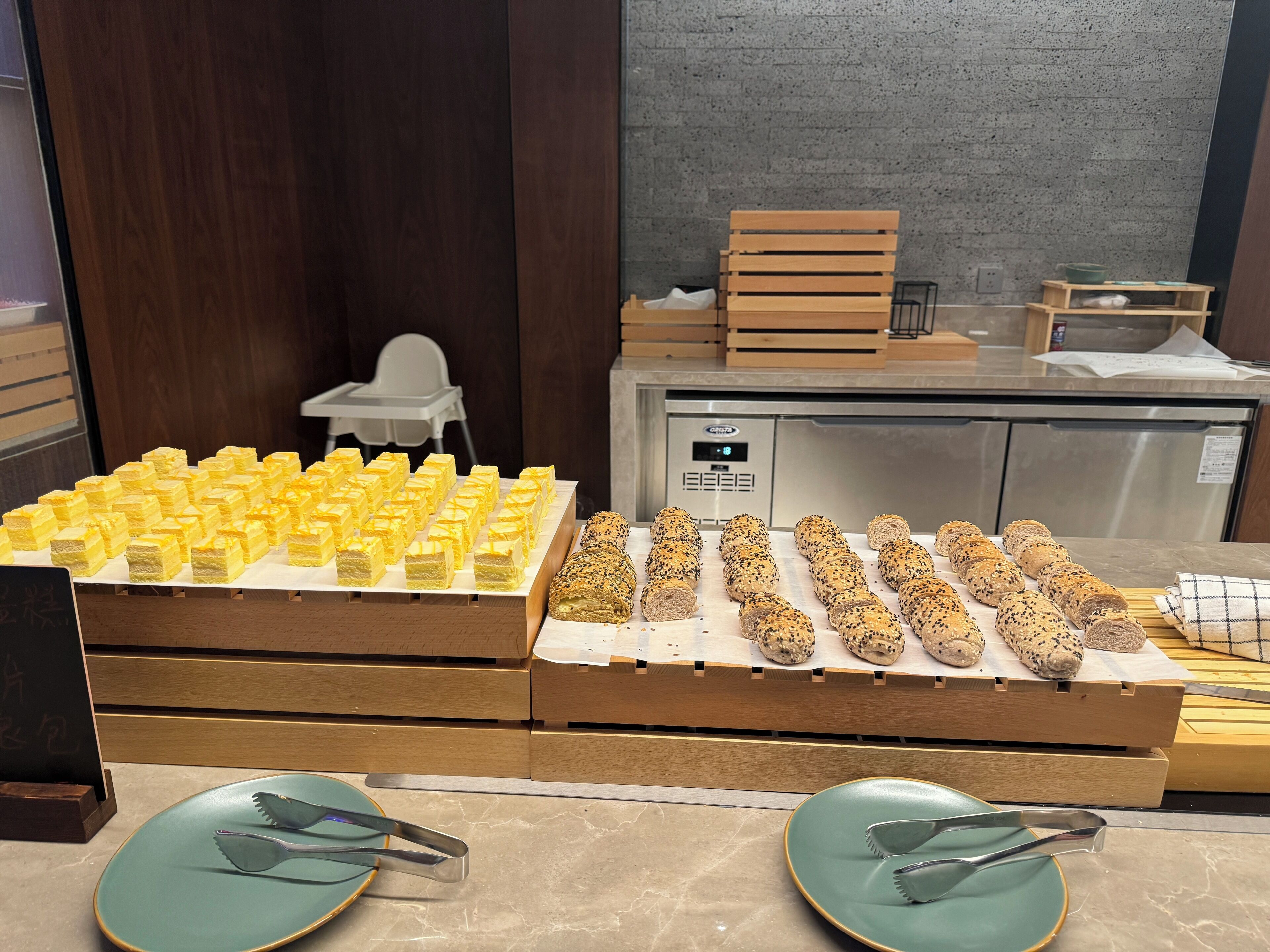 Een buffet met diverse gerechten, waaronder broodjes en een keuze aan desserts.