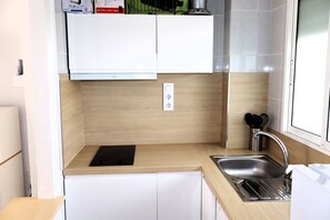 Fridge, microwave, coffee/tea maker, cookware/dishes/utensils