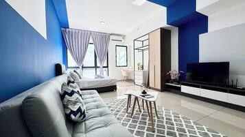 Design Studio, 1 Queen Bed, City View | Living area | 50-inch Smart TV with digital channels, foosball