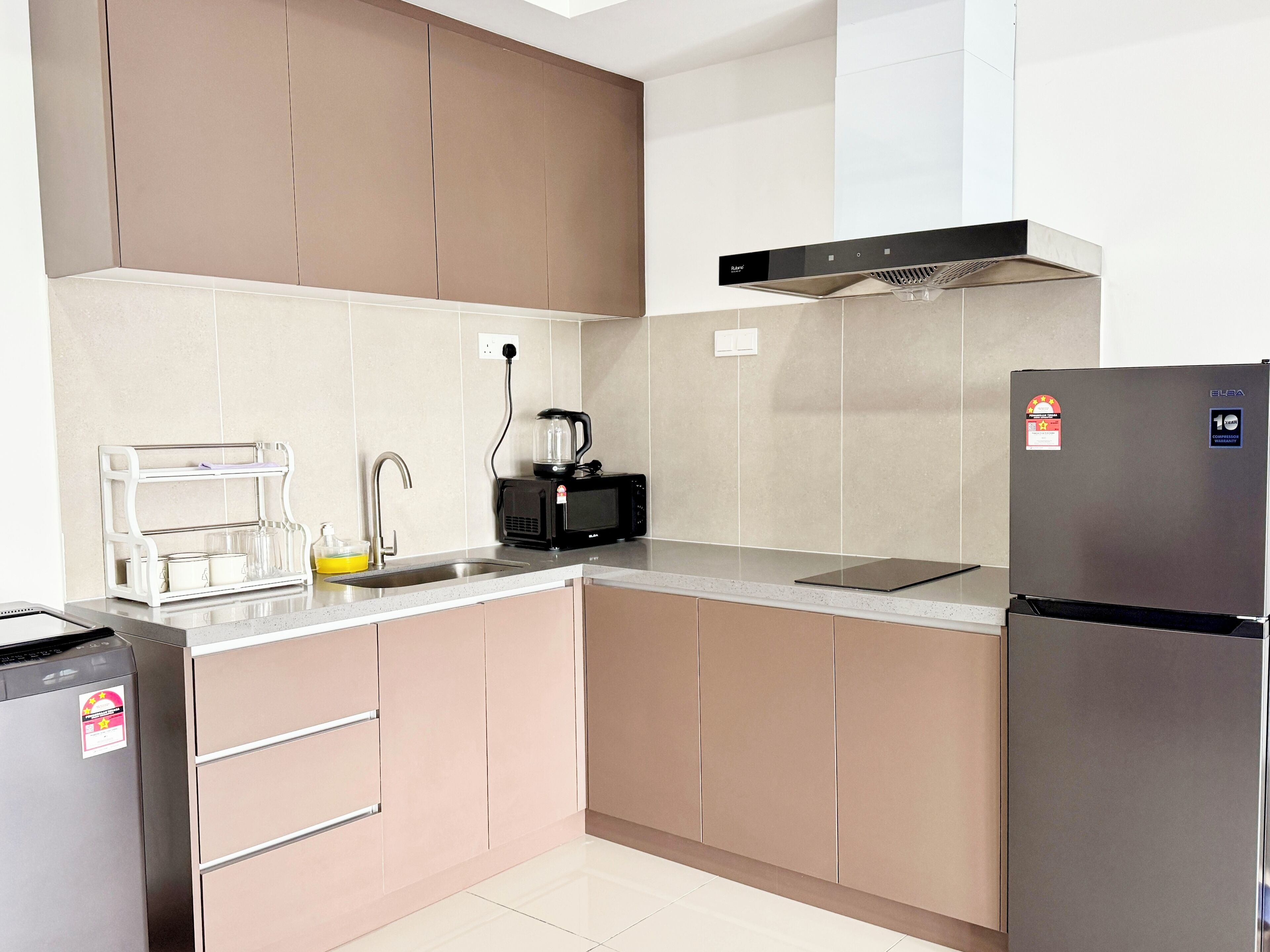 A modern kitchen with stainless steel appliances, a built-in oven, and a microwave.