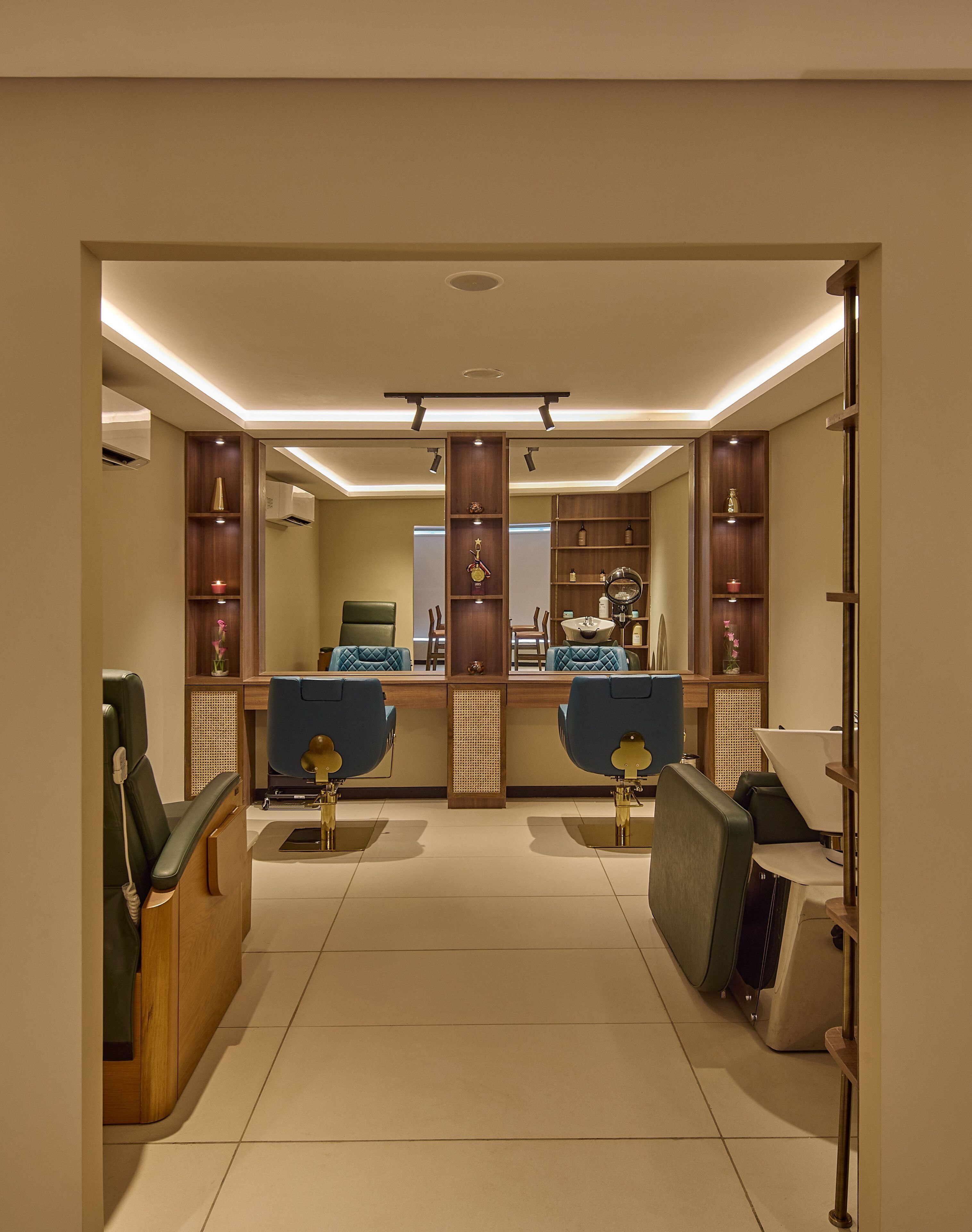 A well-lit room with a reception desk, two seating areas with chairs, and shelves with various items.