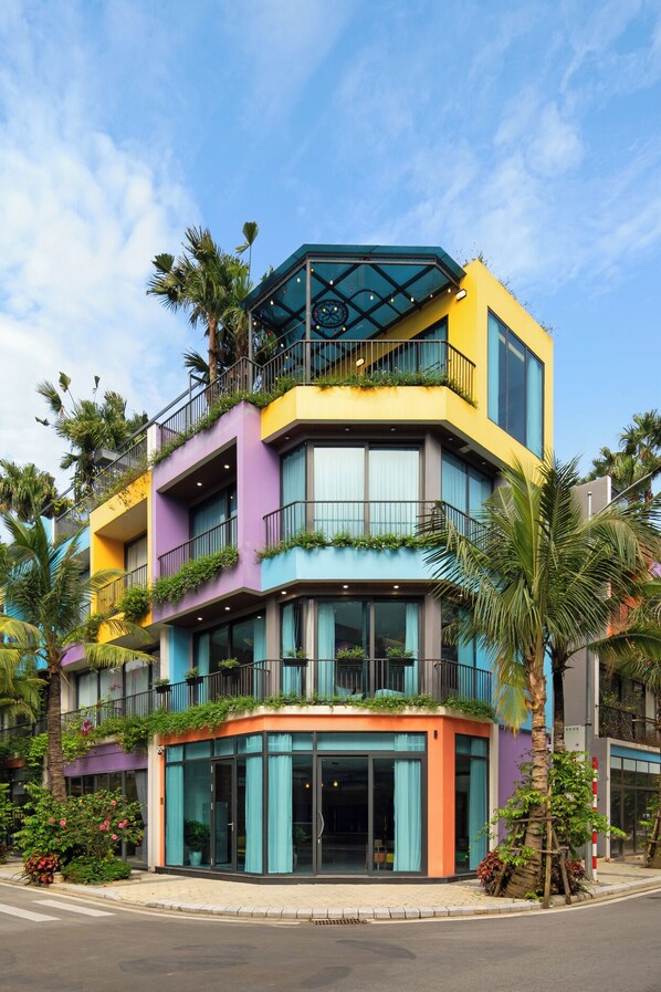Stunning multi-story building with balconies, large windows, and a unique glass enclosure.