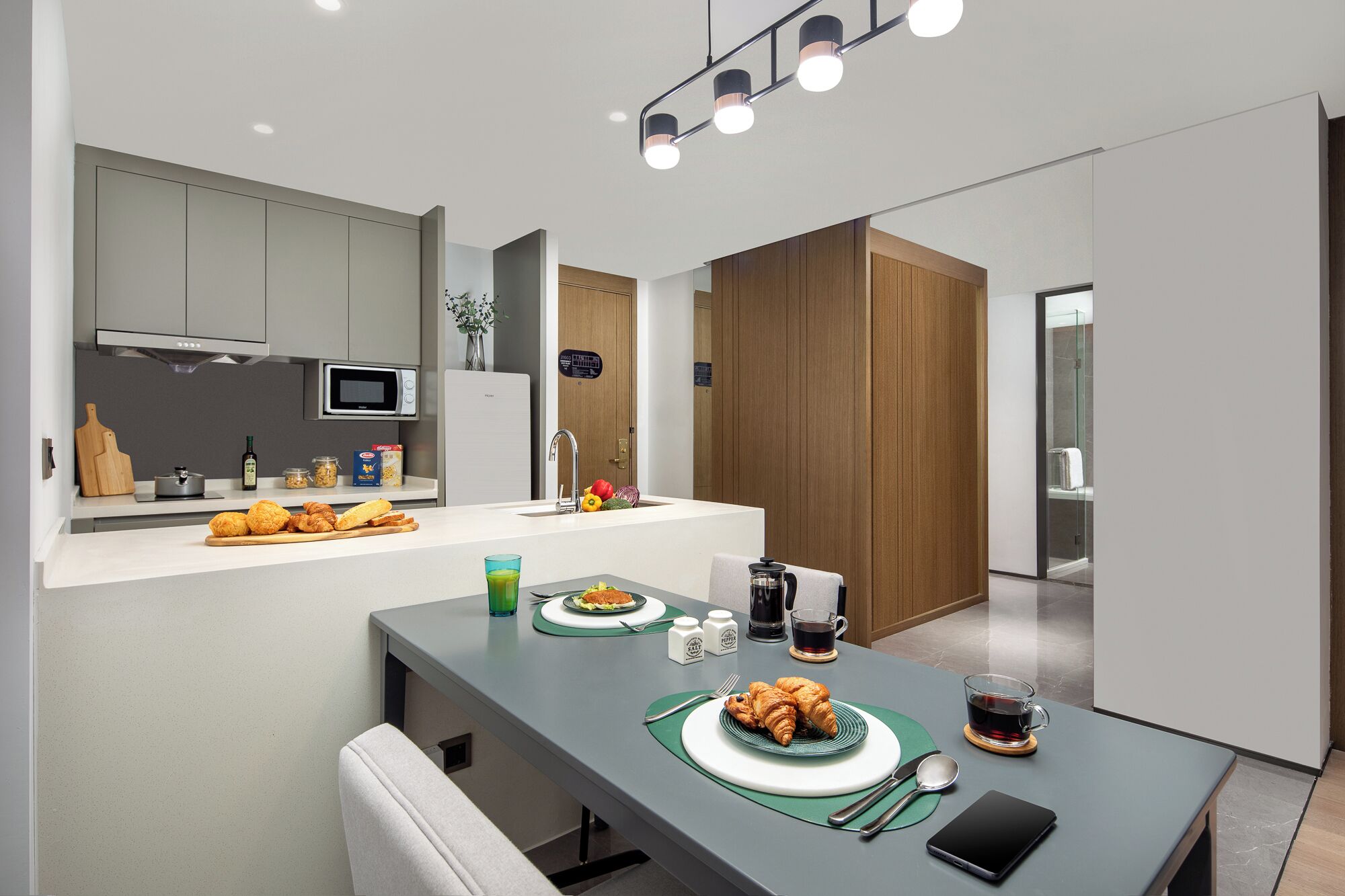 A modern kitchen with a dining area.