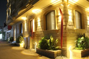 A historic building with arched windows and a well-lit facade. - Three Pyramids Boutique Hotel (Giza)