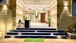 The entrance to a hotel named "Three Pyramids" with marble steps and a reception desk. - Three Pyramids Boutique Hotel (Giza)