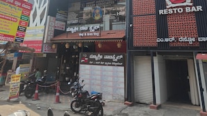 A building with multiple businesses including a restaurant and a notary service. - Hotel Golden Arch  (Bangalore)