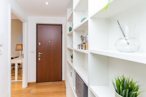Cozy retreat with a wooden floor, white shelving units, and a small potted plant.