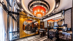 A luxurious lobby with a grand chandelier, marble flooring, and a piano. - APA Hotel Suidobashi Ekimae (Tokyo)