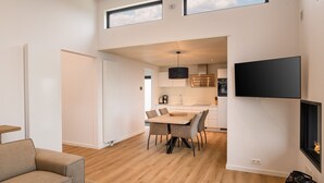 A modern apartment with a dining area, kitchen, and living space. - Ground floor bungalow for 4 persons (Herkingen)