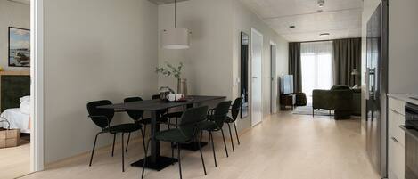 A modern kitchen with a refrigerator, stove, and sink.