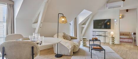 Suíte conforto, vista para a cidade | Área de estar | TV de tela plana