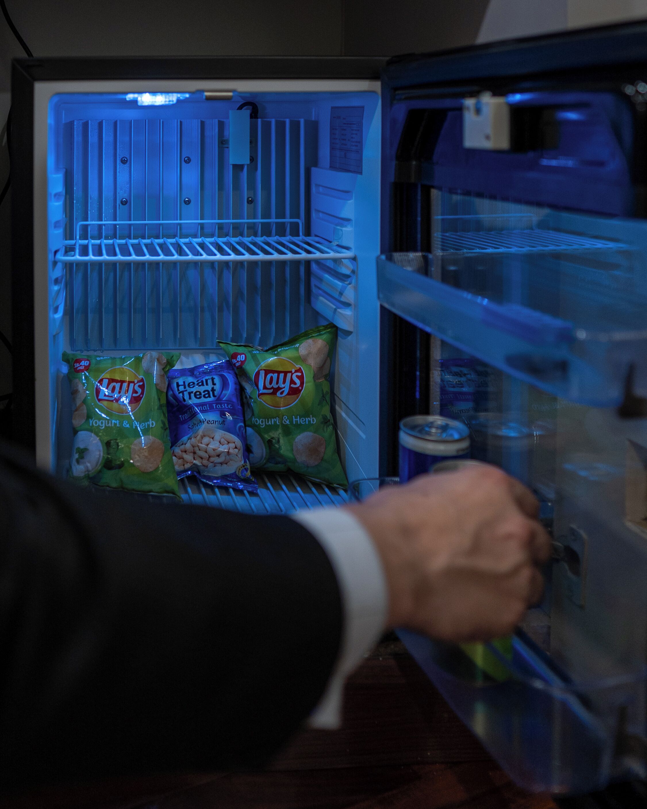 An open refrigerator with shelves and a crisper drawer.