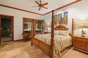 A spacious bedroom with a four-poster bed, a ceiling fan, and a balcony with a view. - 🌴Aloha Moana Penthouse  | Elevator | Ocean View | Beach Access🌴 (Waikoloa)