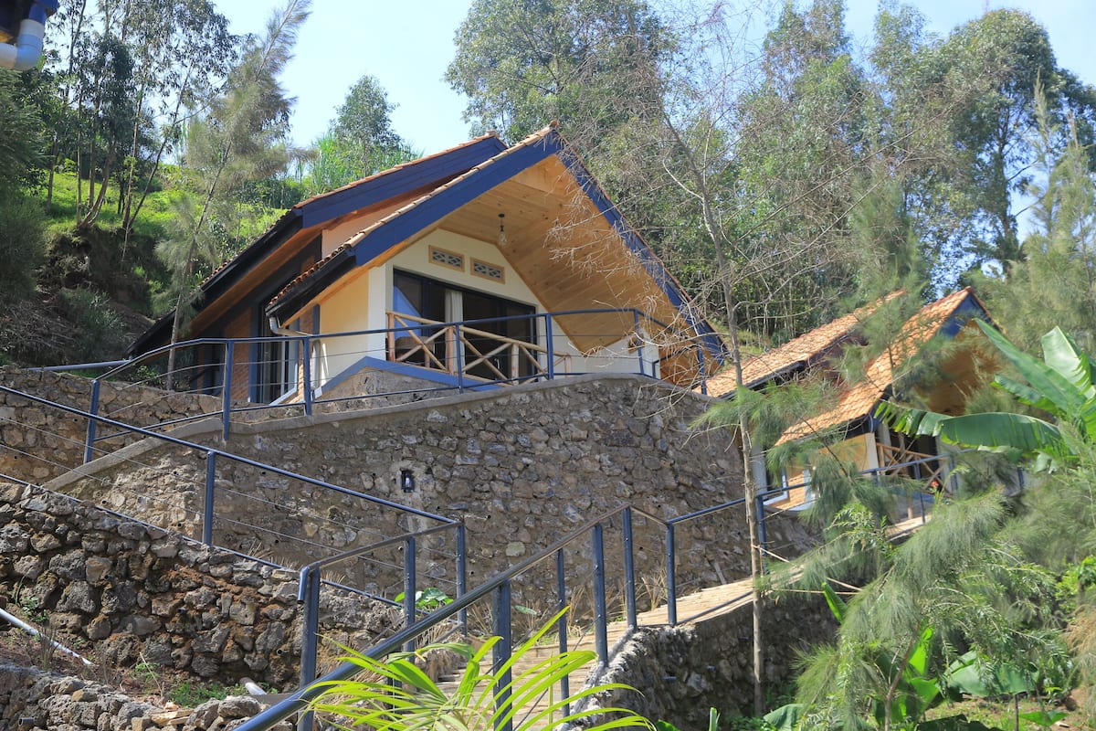 A stone staircase leading to a wooden-roofed building with a balcony.