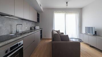 Apartment (1 Bedroom) | Living area | 32-inch TV with cable channels