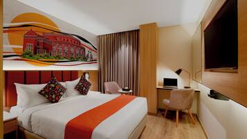 A hotel room with a bed, a desk, a chair, a TV, and a painting on the wall.