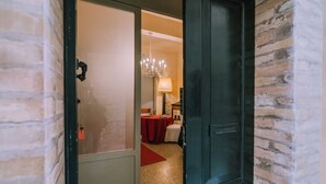 A hotel room with a door leading to a dining area. - In the city center, 7 km from the sea (Fermo)