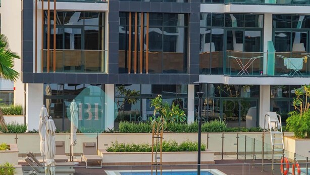 A modern hotel with a rooftop pool, outdoor seating, and lush landscaping. - Bloomfields Cozy STU Azizi Riviera Meydan (Dubai)