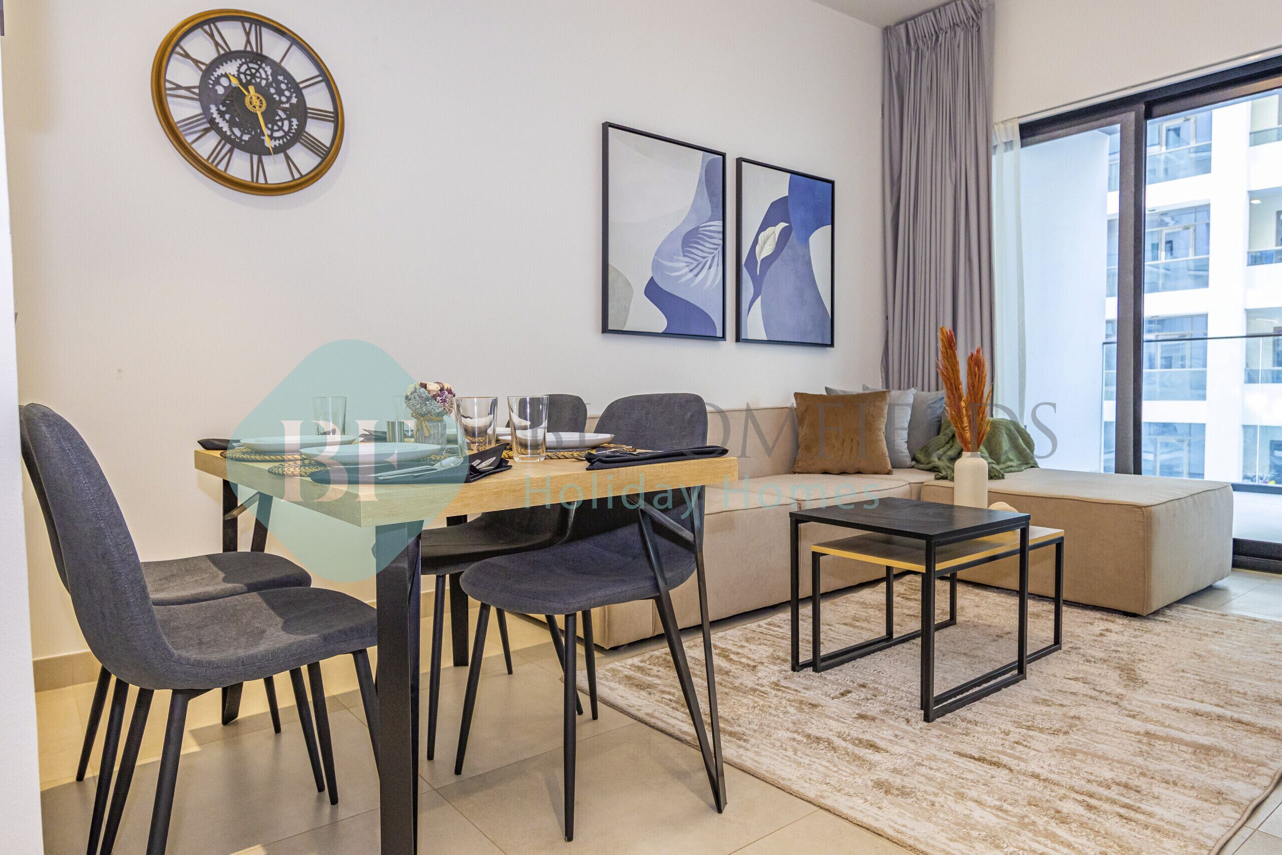 A modern living room with a glass dining table, two chairs, a sofa, a coffee table, a clock, and abstract wall art.