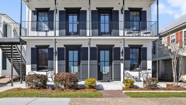 A two-story residential building with a balcony, a front door labeled '782 B', and a small front yard with shrubs. - Old Spanish House Vivian Suite A. Sophisticated Retreat, Beach, Fire Pit, Downtown, Golf Cart (Biloxi)