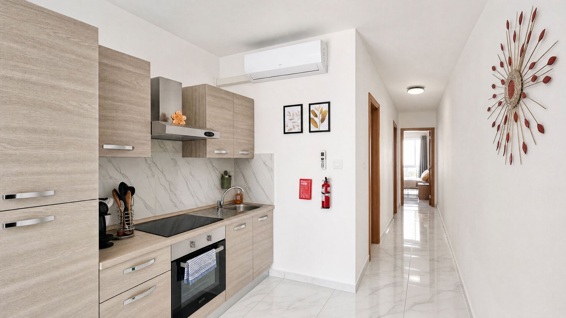 A modern kitchen with wooden cabinets, a built-in oven, and a marble backsplash.