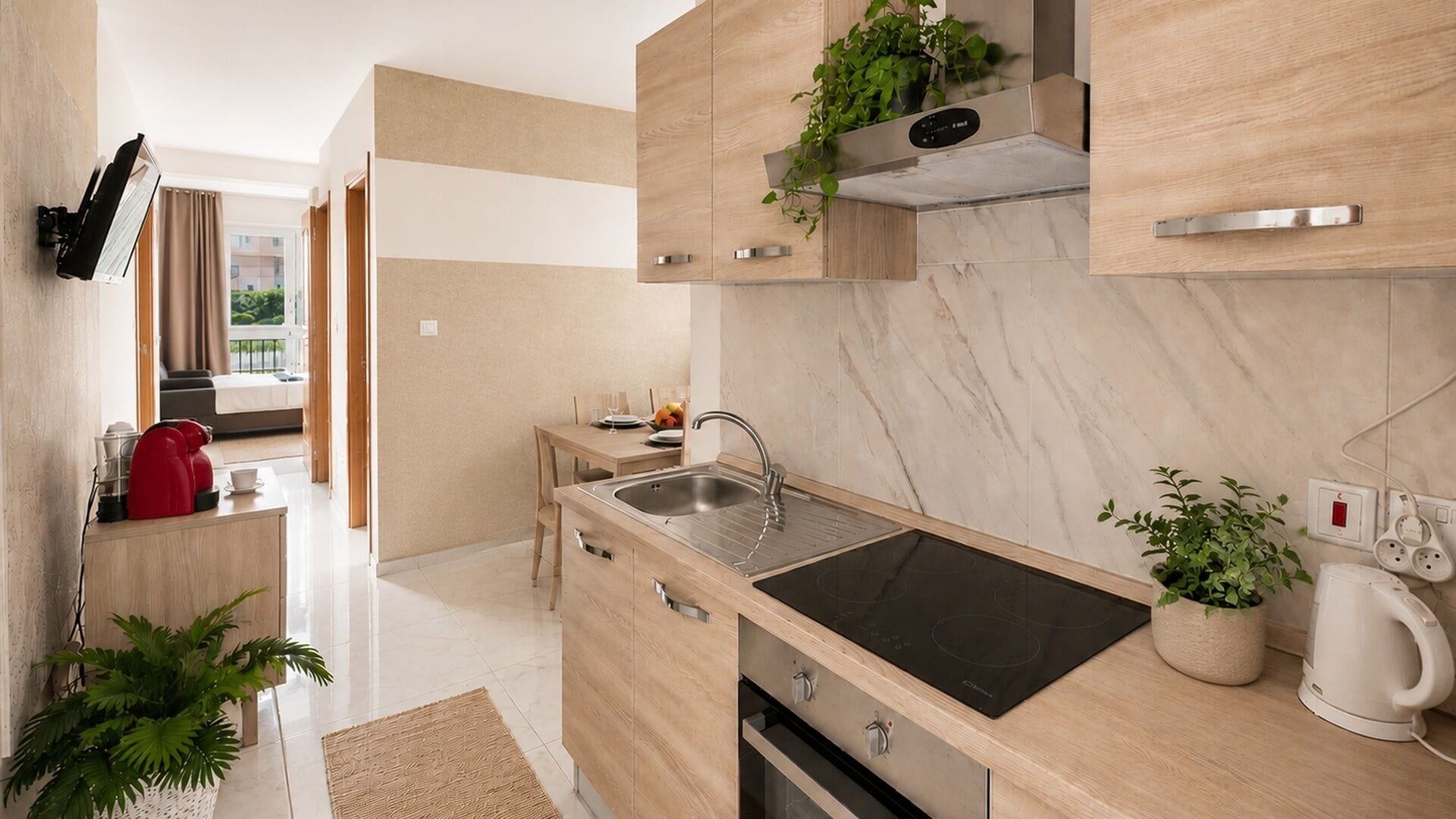 A modern kitchen with a built-in stove, a sink, and wooden cabinets.