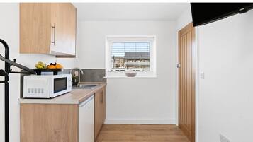 Fridge, microwave, electric kettle, cookware/dishes/utensils