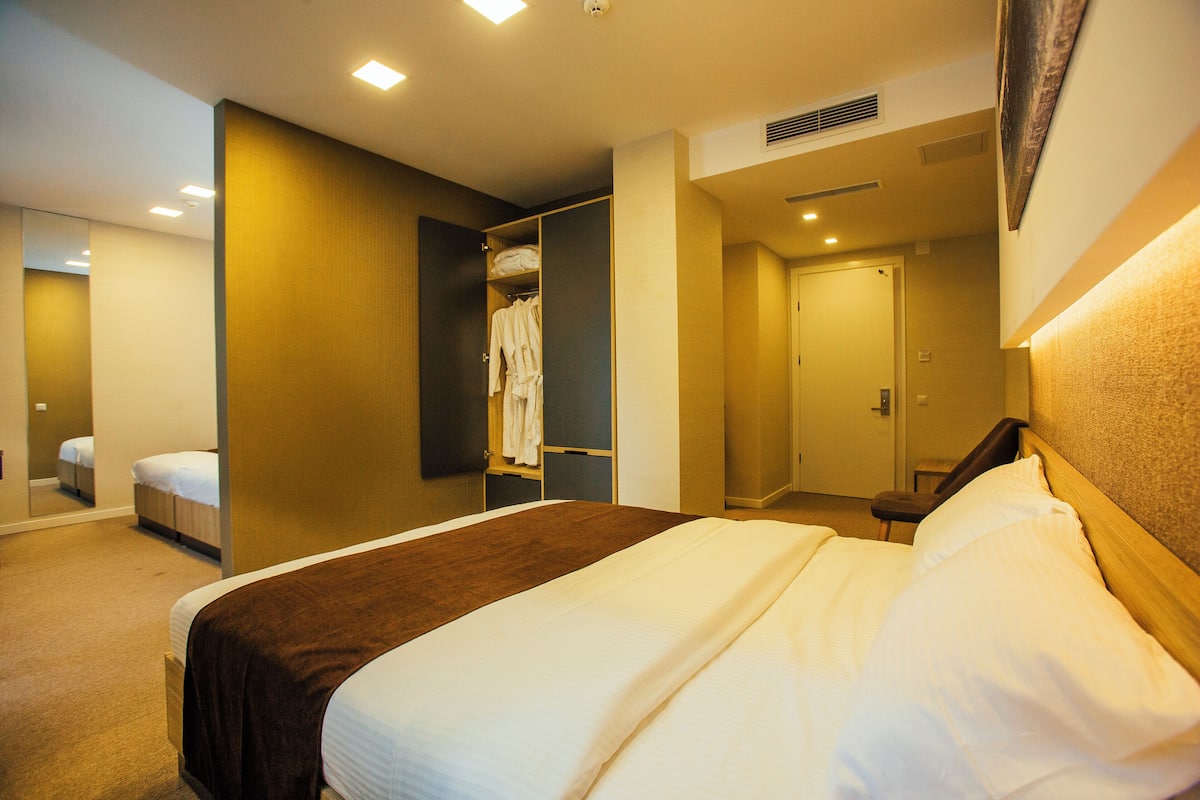 Deluxe Quadruple Room, Balcony, City View | Desk, laptop workspace, free WiFi