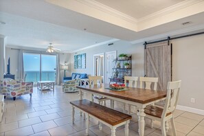 Relax in this spacious living area with a large dining table and comfortable seating.
