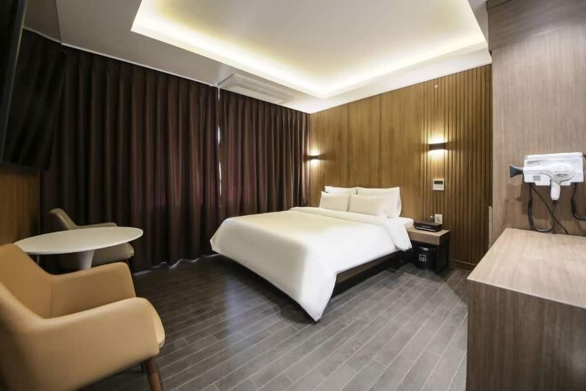 Premium bedding, memory-foam beds, desk, laptop workspace