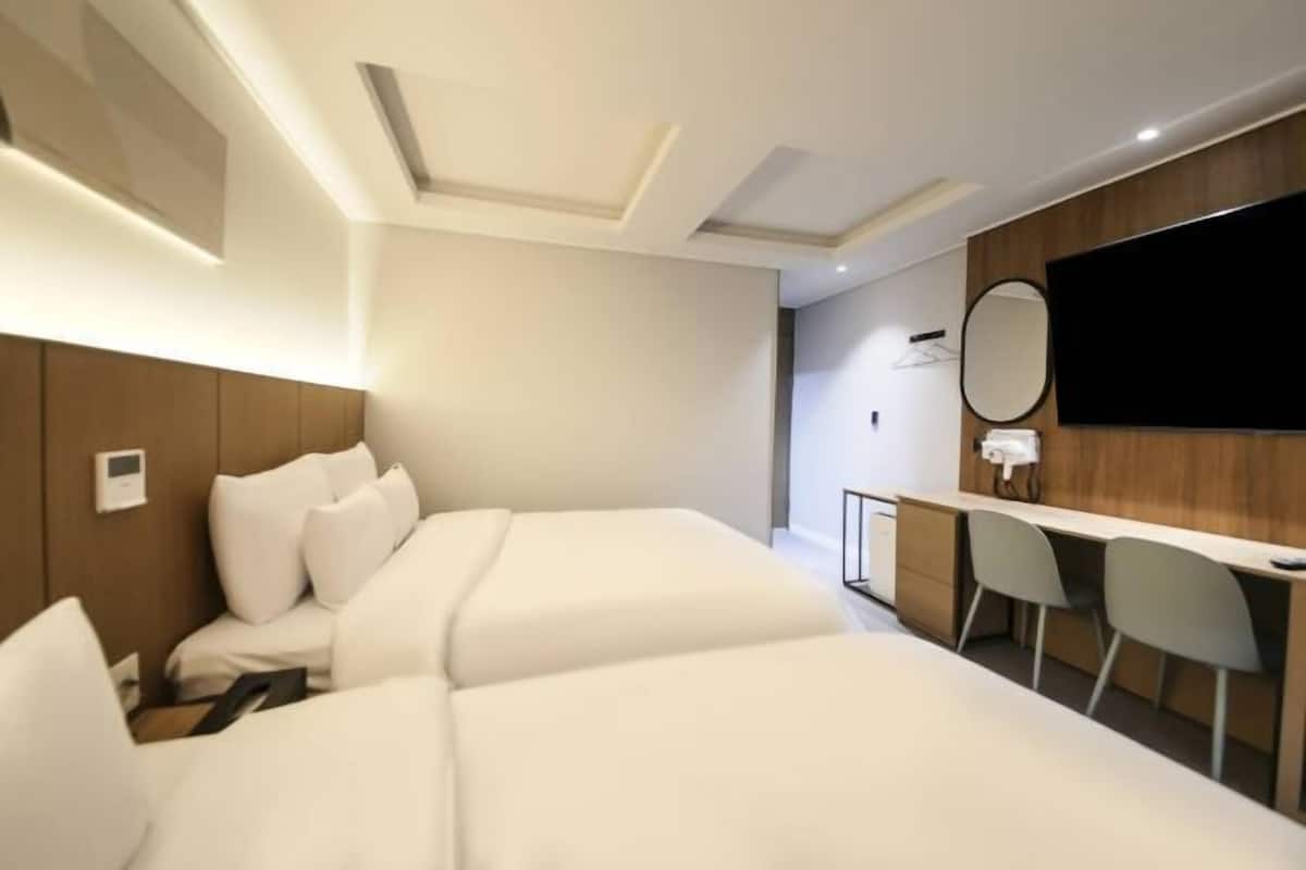 Premium bedding, memory-foam beds, desk, laptop workspace
