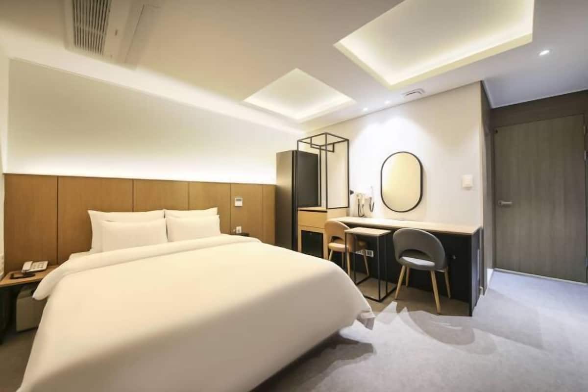 Premium bedding, memory-foam beds, desk, laptop workspace