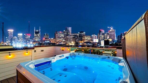 A hot tub on a rooftop with a city skyline in the background. - Disco Lounge Double Rooftop Hot Tub Nashville (Nashville)