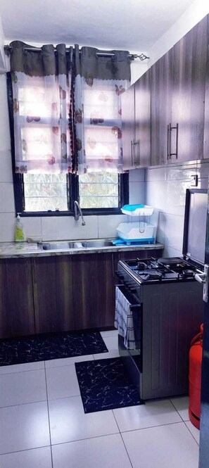 Fridge, microwave, cookware/dishes/utensils, dining tables